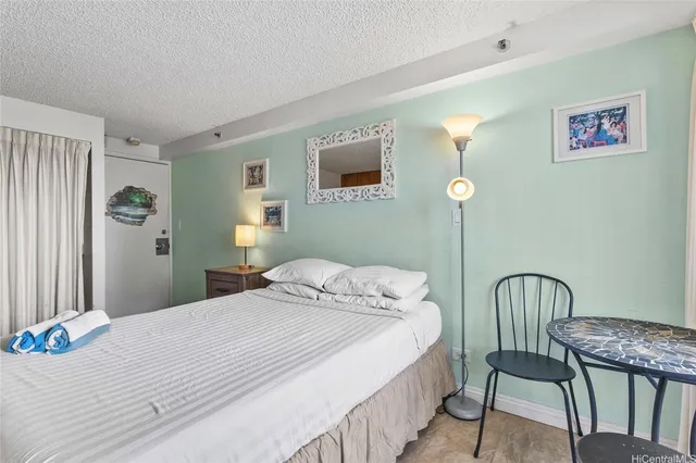 a bedroom with a bed and a table