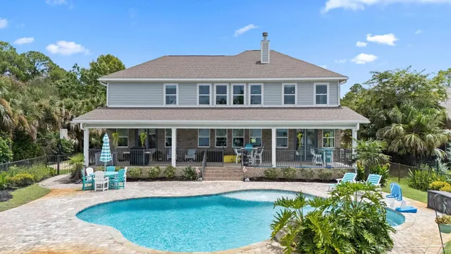 a view of a swimming pool with an outdoor space and seating area
