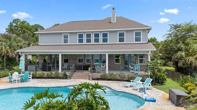 a view of a house with a yard and sitting area