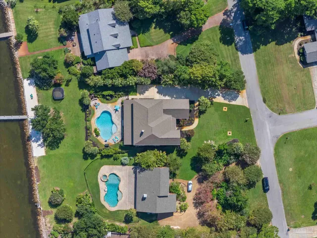 an aerial view of a house with a swimming pool yard and outdoor seating
