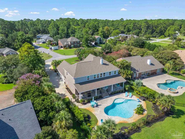 an aerial view of a house with a swimming pool