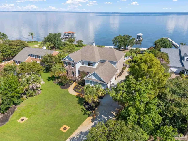 an aerial view of a house with a swimming pool and garden