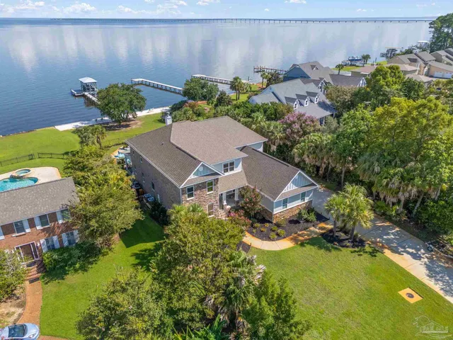 an aerial view of a house with a yard basket ball court and outdoor seating
