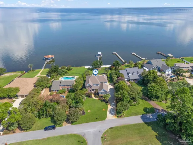 a front view of a house with swimming pool and sitting area