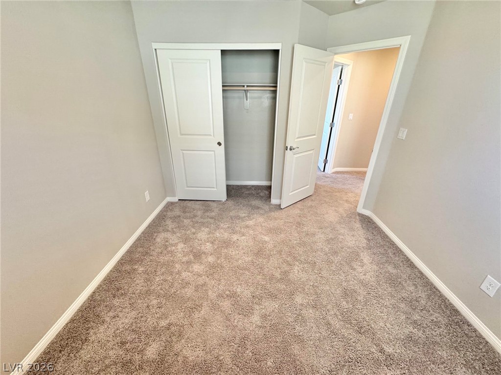 7020 Colonial Ranch Street Las Vegas, NV 89166 - Photo 24 of 37 Plush carpeting and a built-in closet complete this comfortable secondary bedroom space.