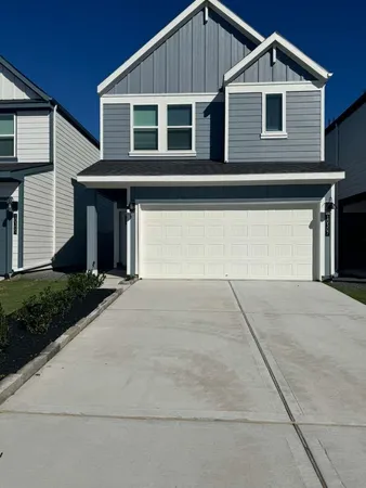 a front view of a house with garage