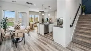 a living room with furniture a couch and a kitchen view