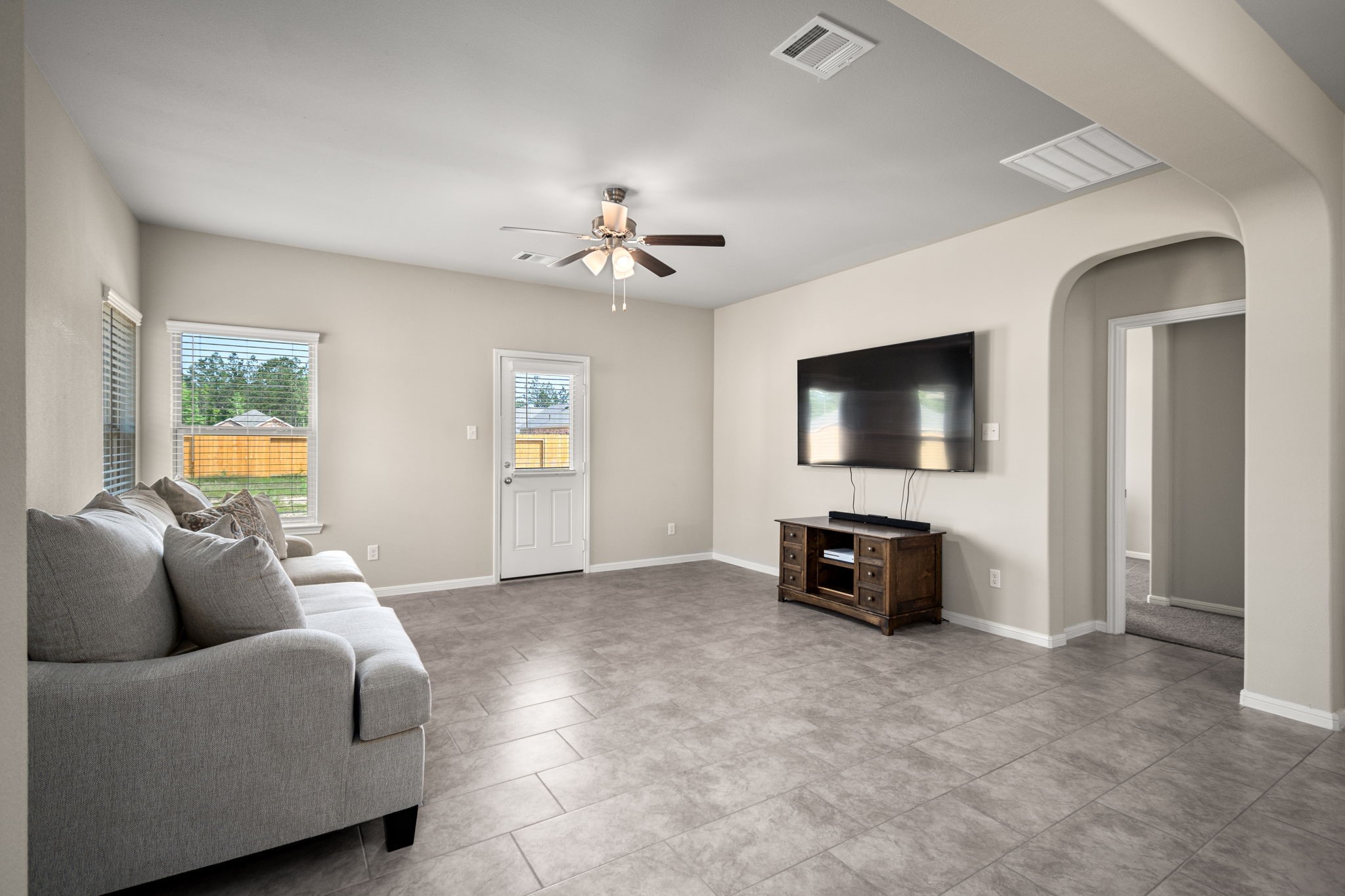 26019 Babe Ruth Drive Splendora, TX 77372 - Photo 12 of 23 a living room with furniture and a flat screen tv