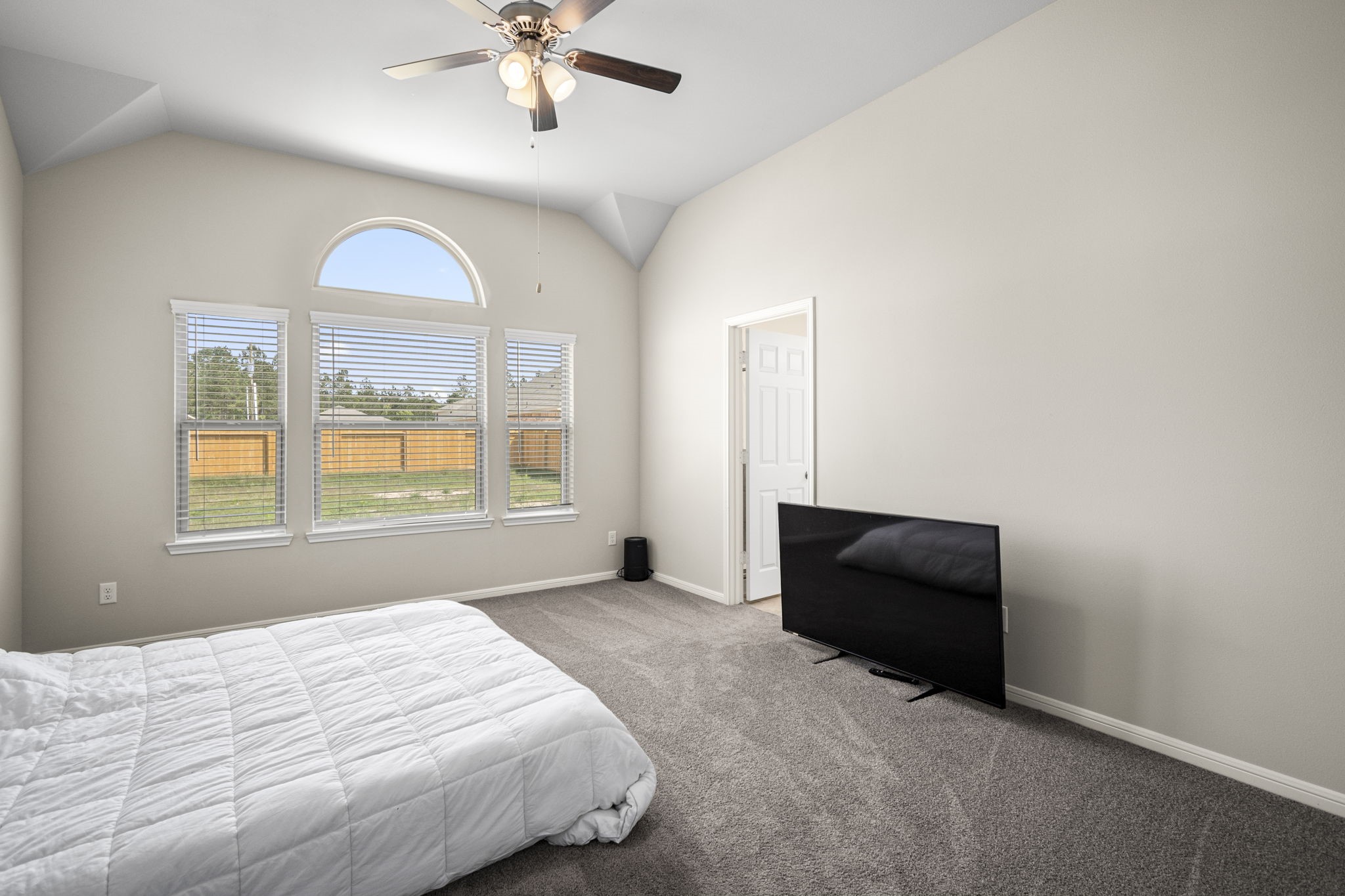 26019 Babe Ruth Drive Splendora, TX 77372 - Photo 17 of 23 a bedroom with a bed and a chandelier