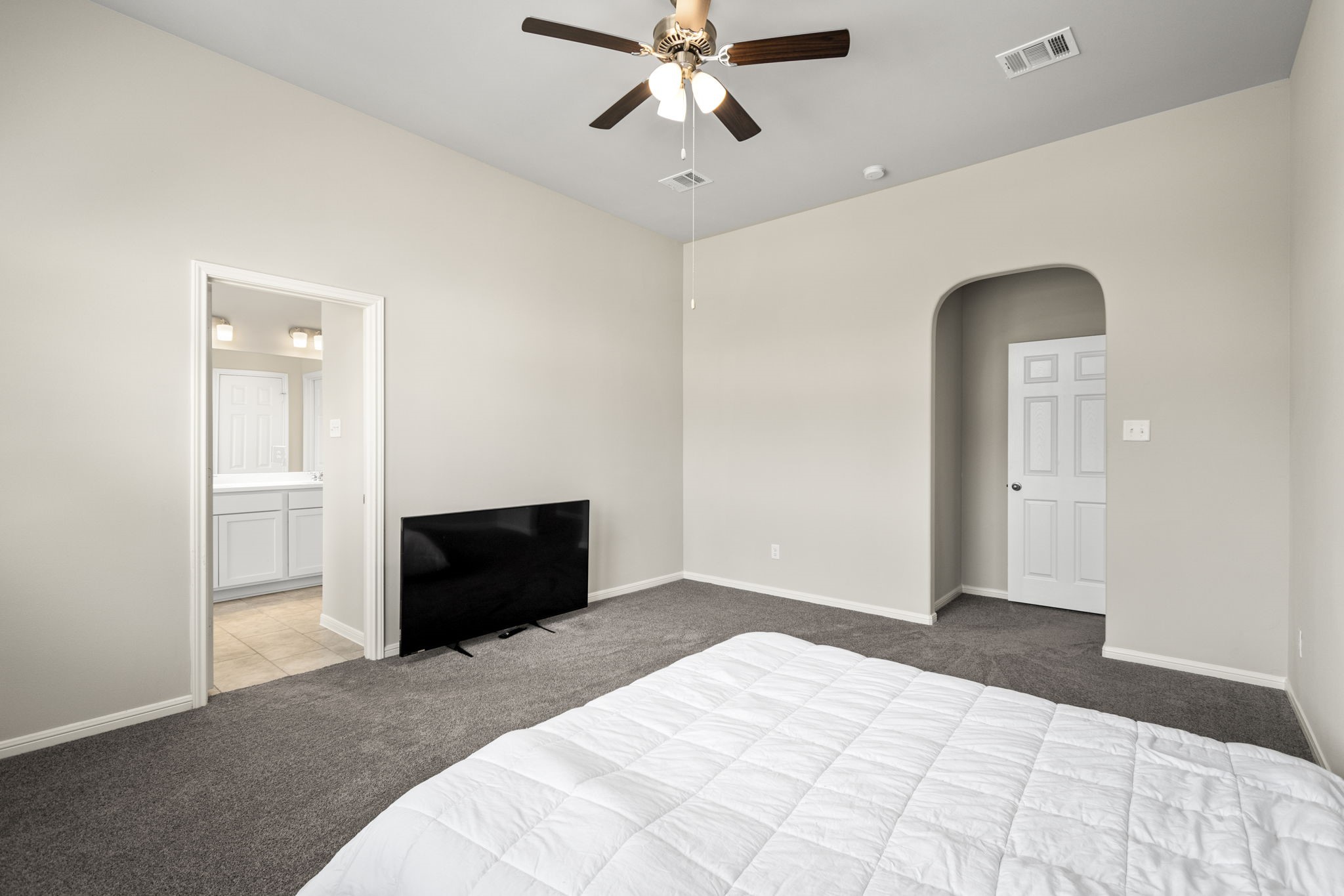 26019 Babe Ruth Drive Splendora, TX 77372 - Photo 18 of 23 a bedroom with a bed and a ceiling fan