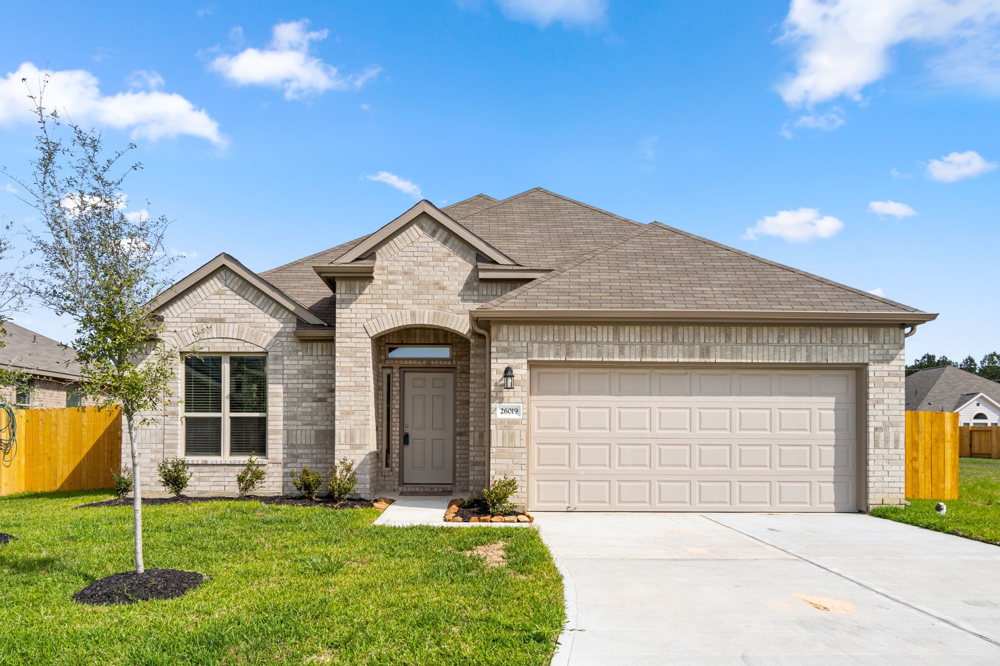 26019 Babe Ruth Drive Splendora, TX 77372 - Photo 2 of 23 a front view of a house with a garden and yard