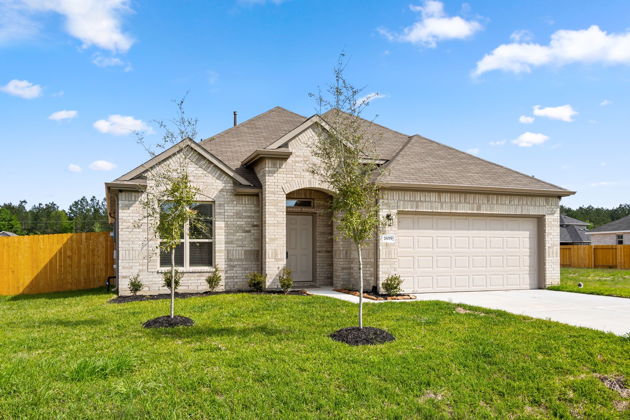 26019 Babe Ruth Drive Splendora, TX 77372 - Photo 3 of 23 a view of a house with a small yard and a large tree