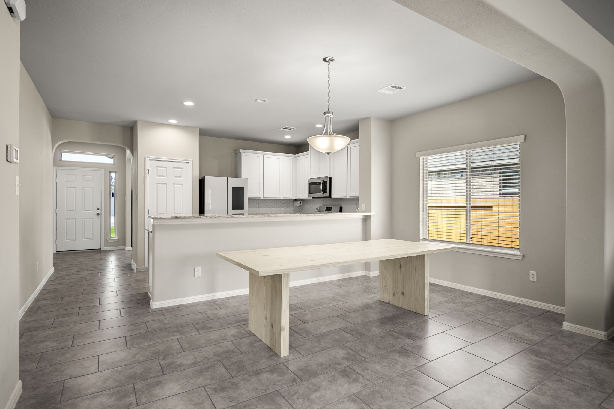 26019 Babe Ruth Drive Splendora, TX 77372 - Photo 9 of 23 a kitchen with kitchen island a stove a refrigerator and a sink