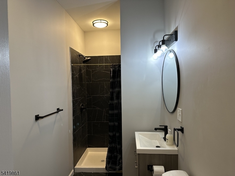 34 Duryea Street Newark, NJ 07103 - Photo 4 of 15 a bathroom with a sink and mirror