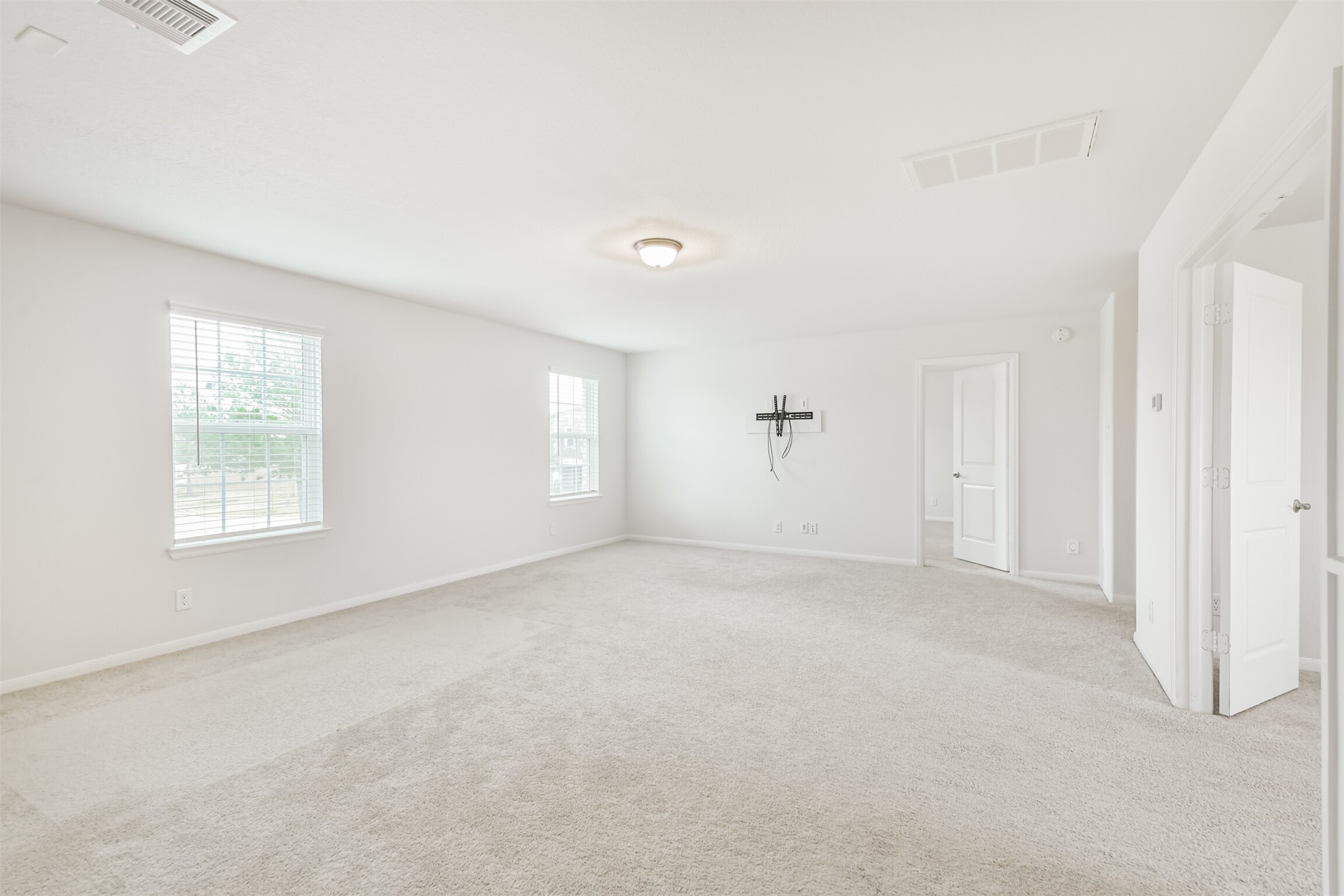 2129 Solstice Boulevard Spring, TX 77386 - Photo 34 of 43 Game Room (Alternate View):
Oversized upstairs game room with multiple windows for great natural light. Neutral paint and carpet make it easy to customize. Plenty of open space for media, play, or additional lounging, with quick access to secondary bedrooms and a full bath.