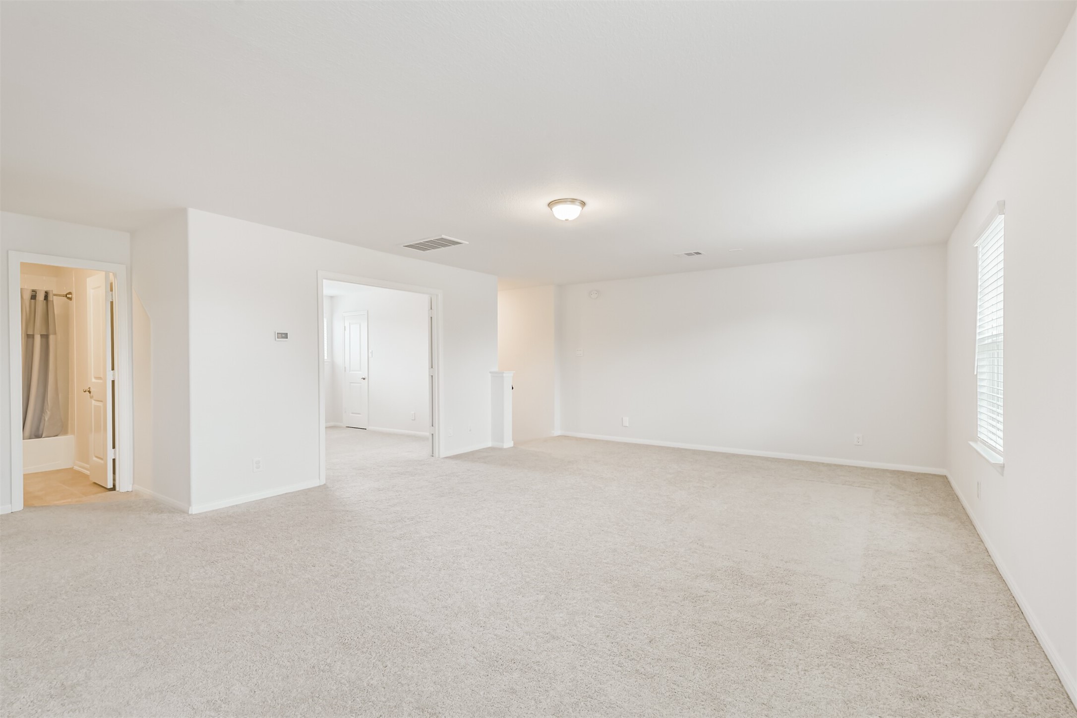 2129 Solstice Boulevard Spring, TX 77386 - Photo 35 of 43 Game Room (Alternate View):
Expansive upstairs game room offering plenty of space for a second living area, playroom, or media setup. Neutral color palette, great natural light, and convenient access to secondary bedrooms and a full bathroom.