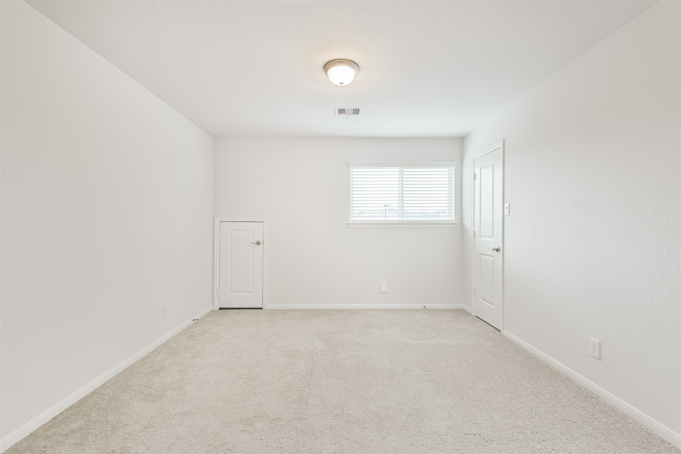 2129 Solstice Boulevard Spring, TX 77386 - Photo 37 of 43 Secondary Bedroom:
Bright secondary bedroom with neutral carpet, a large window for natural light, and convenient closet access. Features an additional small storage door—perfect for seasonal items or extra linens.