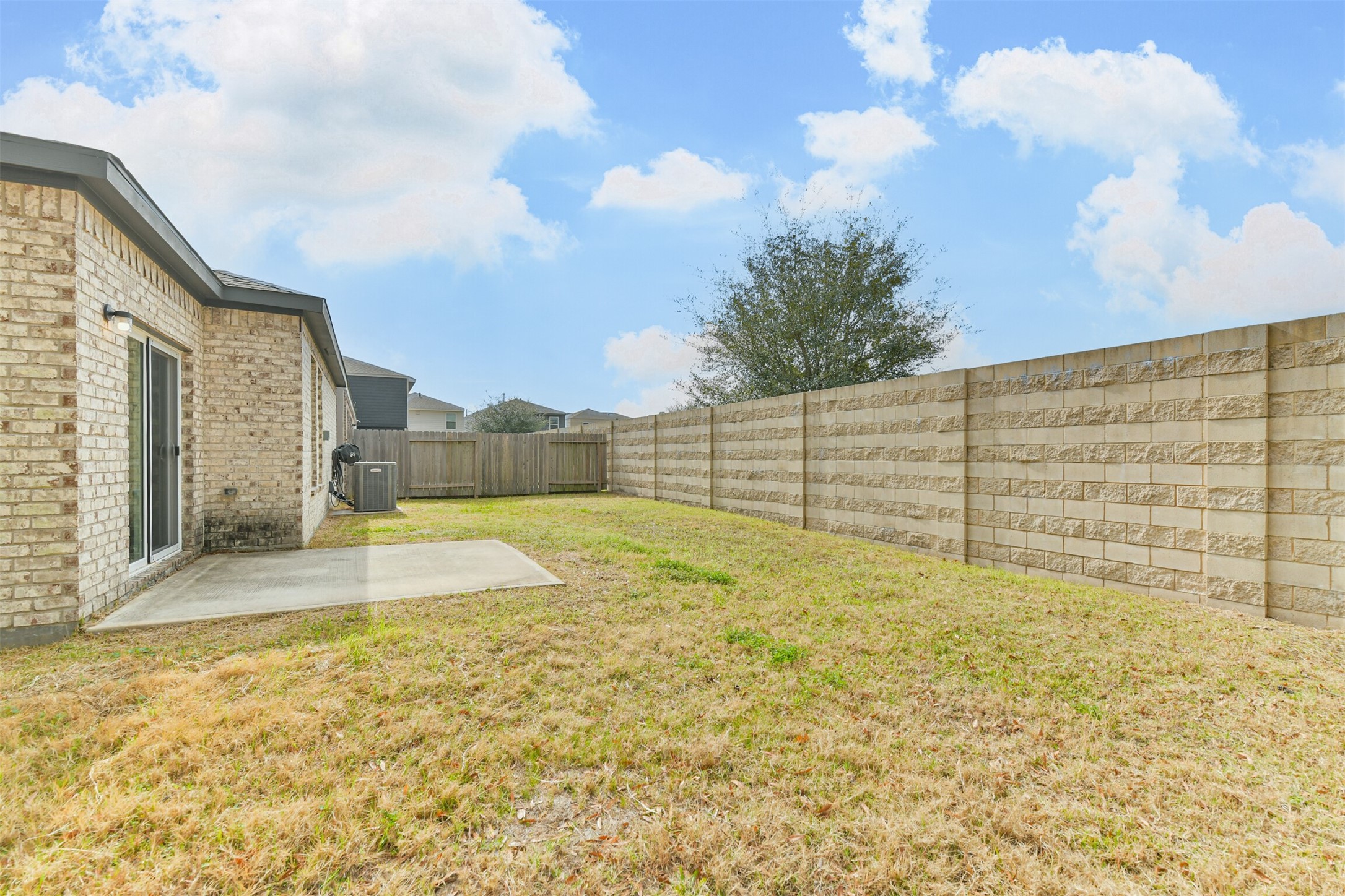 2129 Solstice Boulevard Spring, TX 77386 - Photo 6 of 43 Seating area and a tall privacy wall along the back for added quiet and seclusion. Easy access from the sliding doors and fully fenced for pets or kids.