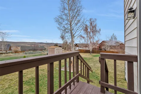 a view of a balcony with wooden fence and floor