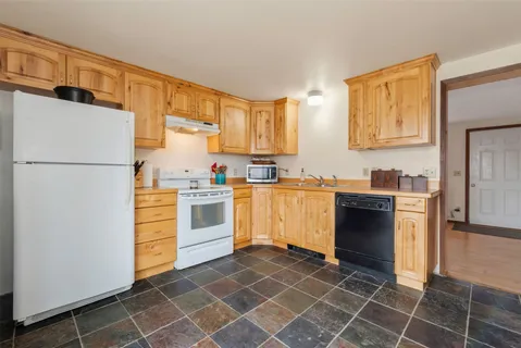 a kitchen with a stove a sink and a refrigerator