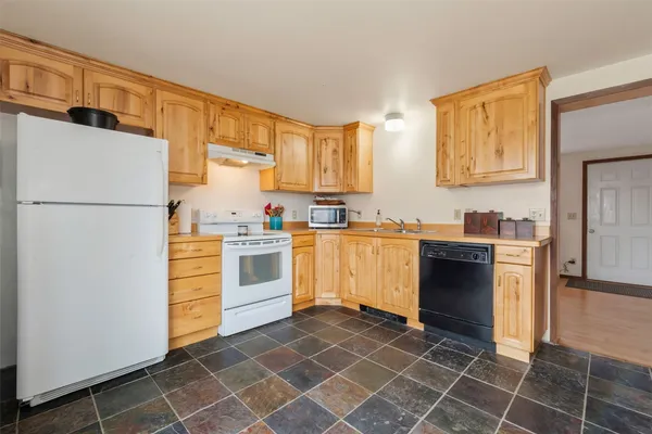 a kitchen with a stove a sink and a refrigerator
