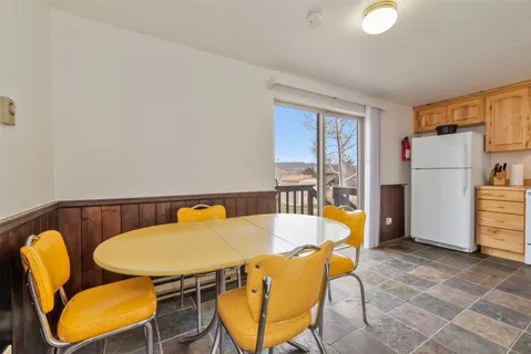 a balcony with table and chairs