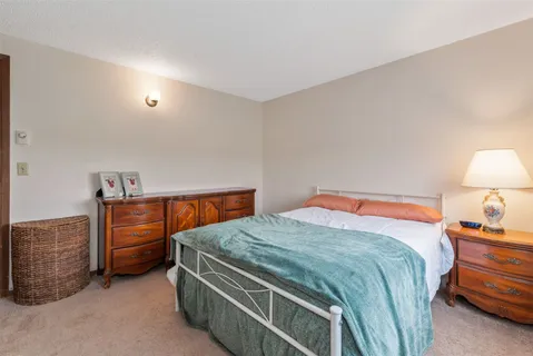 a bedroom with a bed and a dresser