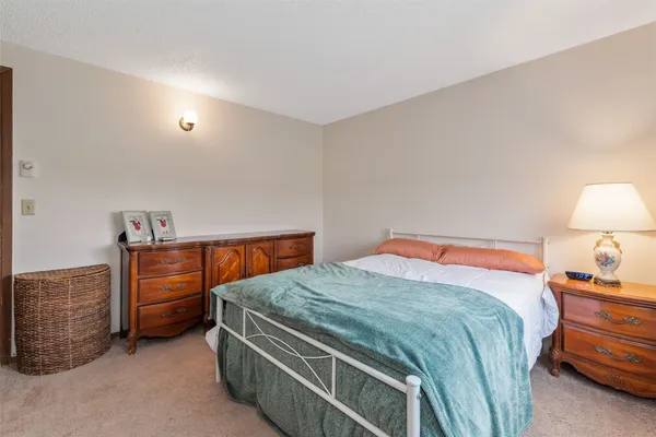 a bedroom with a bed and a dresser