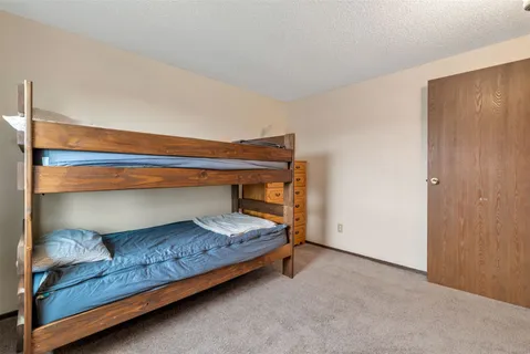 a bedroom with a bed and cabinet