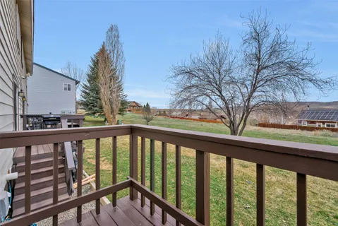 a view of a balcony with wooden fence and floor