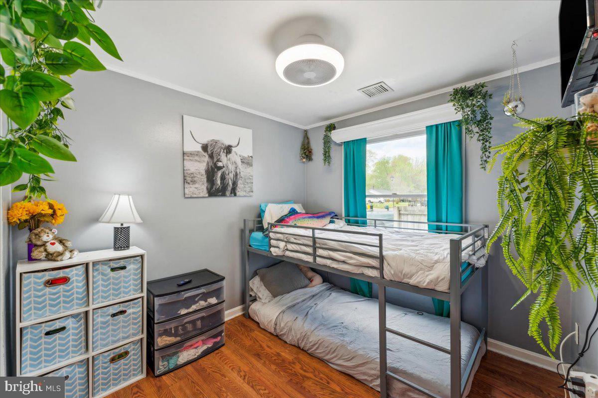 5519 Baskin Street Churchton, MD 20733 - Photo 8 of 20 a bedroom with furniture and a potted plant