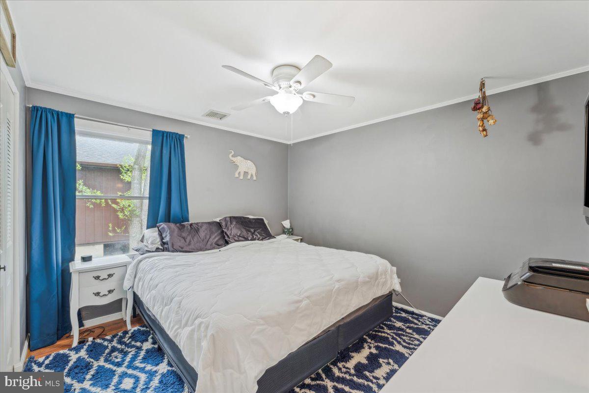 5519 Baskin Street Churchton, MD 20733 - Photo 10 of 20 a bedroom with a bed and a chandelier