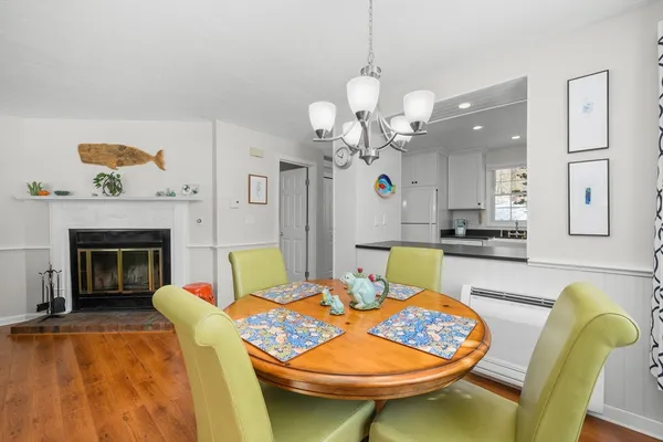 a living room with dining table and a fireplace