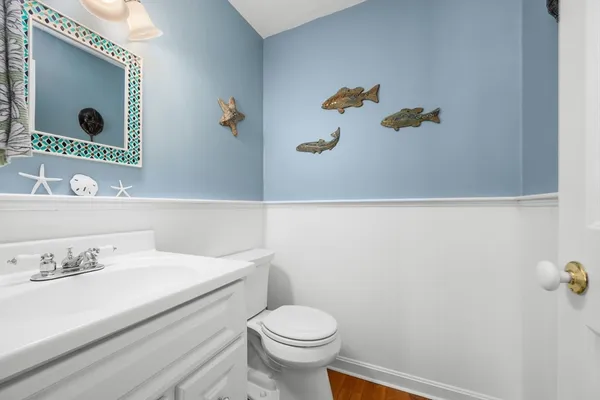 a bathroom with a sink mirror and toilet