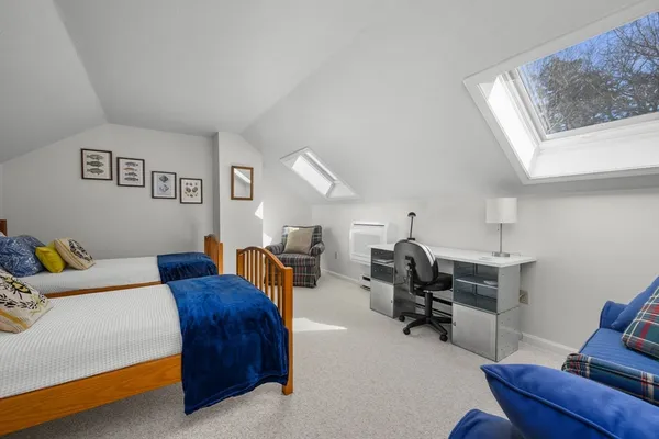 a bedroom with furniture and a window