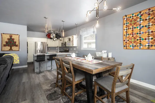 a view of a dining room with furniture and wooden floor