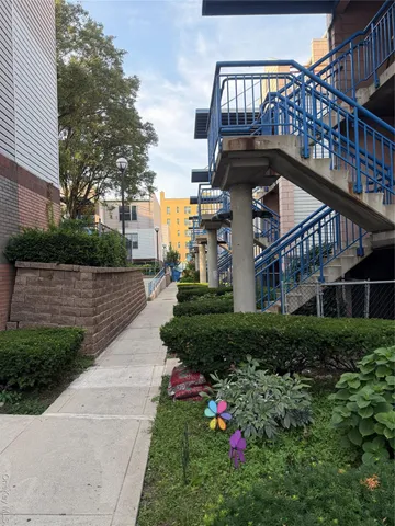 a view of a house with a yard and a large tree