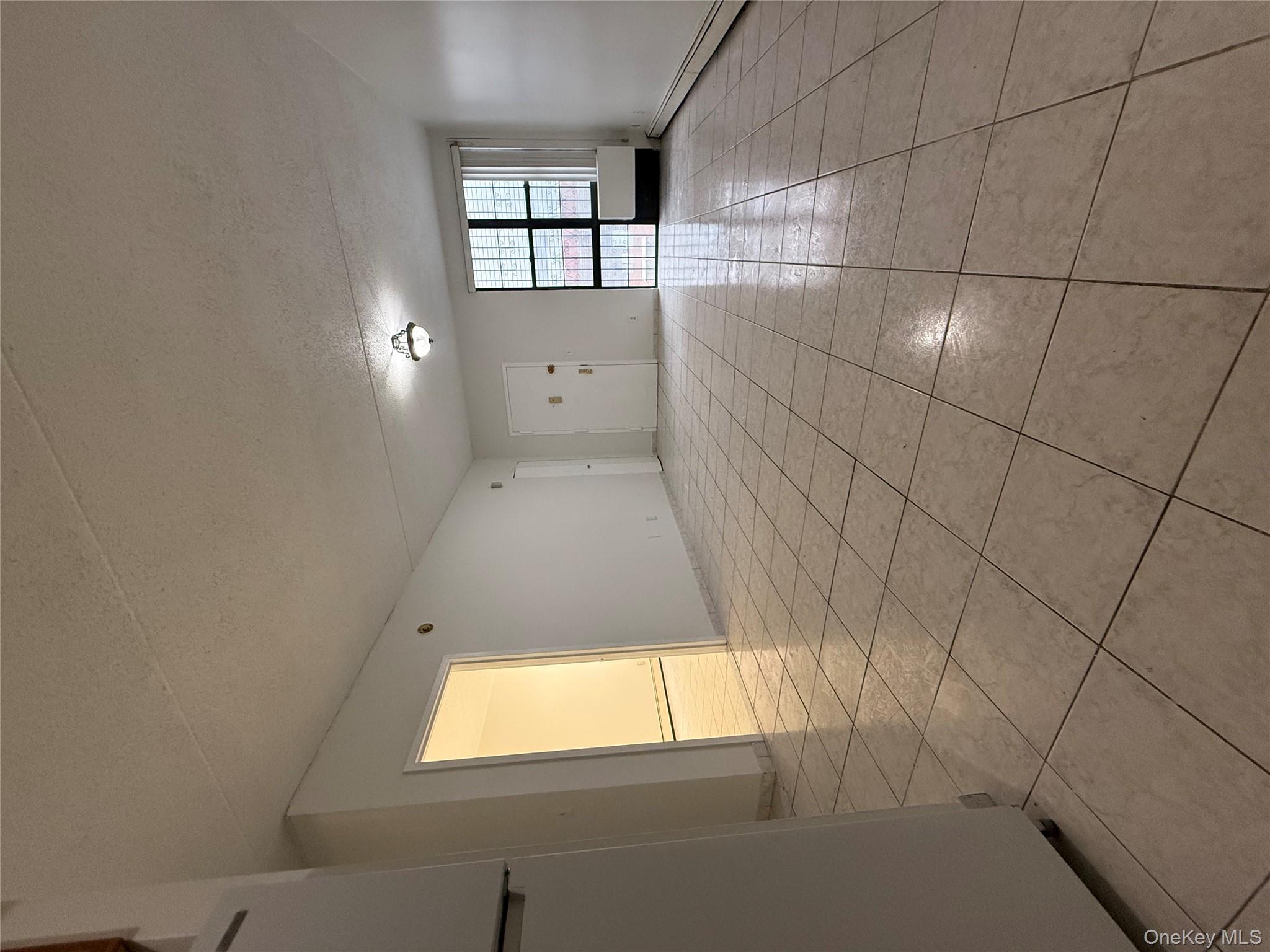 769 St Ann's Avenue, Unit B Bronx, NY 10456 - Photo 3 of 48 a view of an empty room with a window