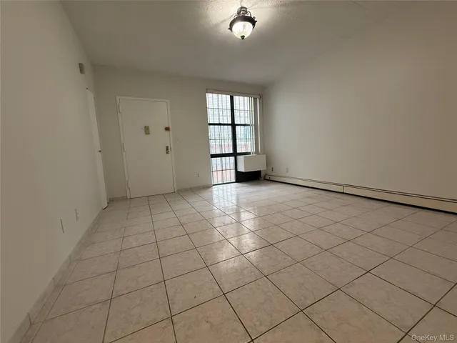 a view of a livingroom with white floor and cabinets
