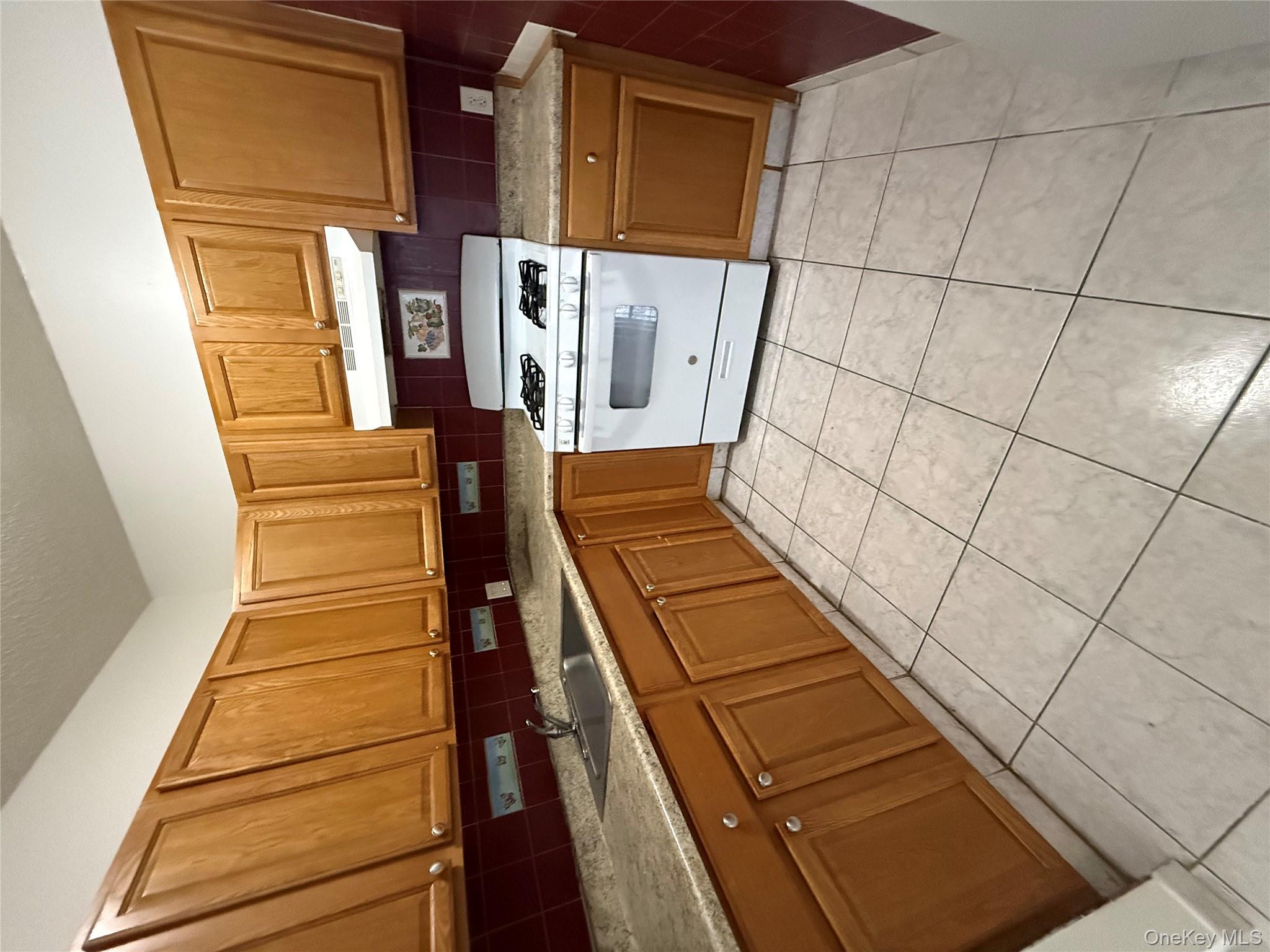 769 St Ann's Avenue, Unit B Bronx, NY 10456 - Photo 44 of 48 a kitchen with a stove a sink and a microwave