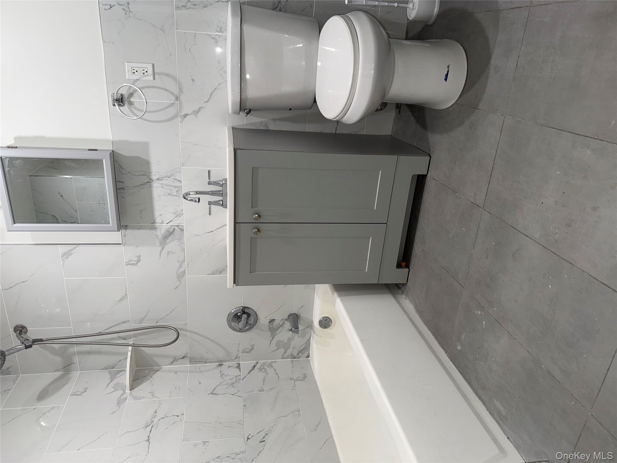 769 St Ann's Avenue, Unit B Bronx, NY 10456 - Photo 5 of 48 a bathroom with a sink a toilet and bathtub