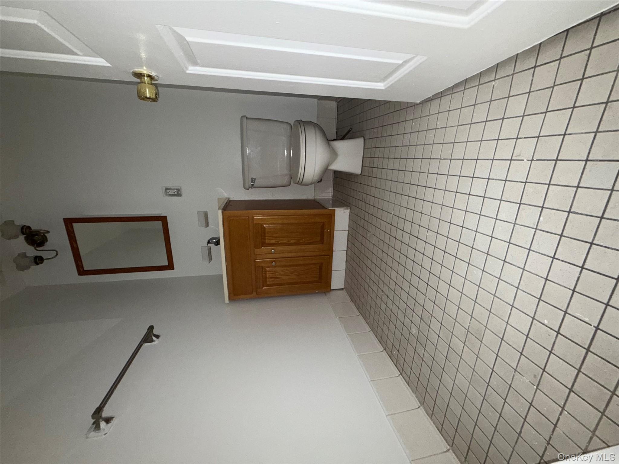 769 St Ann's Avenue, Unit B Bronx, NY 10456 - Photo 7 of 48 a bathroom with a sink toilet and mirror