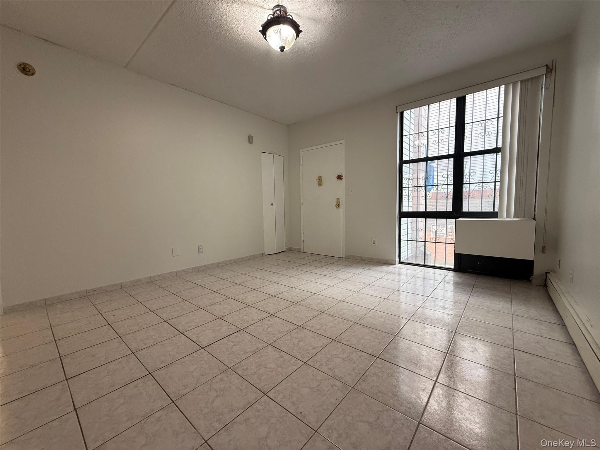769 St Ann's Avenue, Unit B Bronx, NY 10456 - Photo 8 of 48 an empty room with windows
