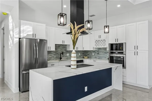 a kitchen with appliances a sink and cabinets