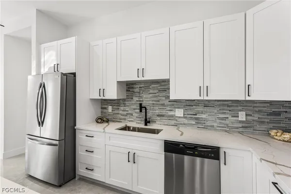 a kitchen with stainless steel appliances a cabinets and a counter top space