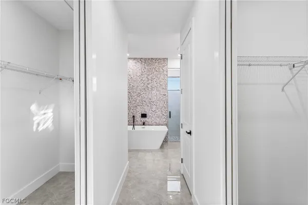 a bathroom with a double vanity sink mirror and shower