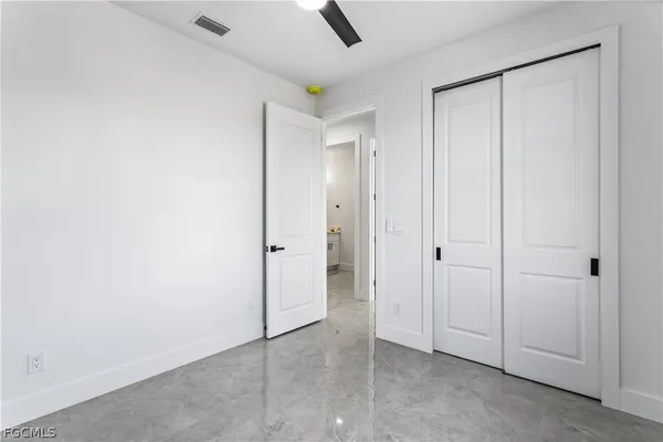 an empty room with windows and painted walls