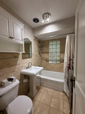 a bathroom with a sink a toilet and bathtub