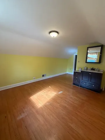 a view of a room with wooden floor