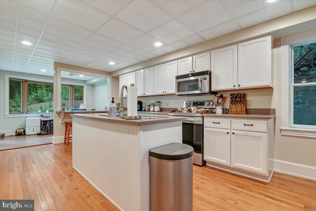 3585 Fairyland Road Lehighton, PA 18235 - Photo 15 of 109 a kitchen with stainless steel appliances granite countertop a refrigerator a sink dishwasher a stove and white countertops with wooden floor
